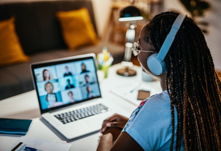 Student looks at computer screen for an online meeting.